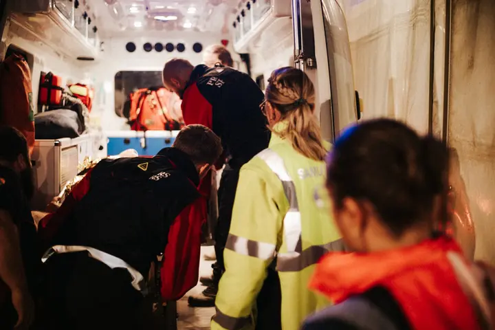Des secouristes et une professionnelle de santé travaillent dans un véhicule de secours
